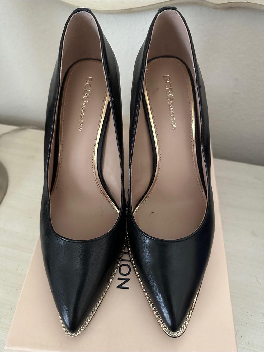 7.5 BCBGeneration Black Pointed Toe Pumps with Gold Chain Trim